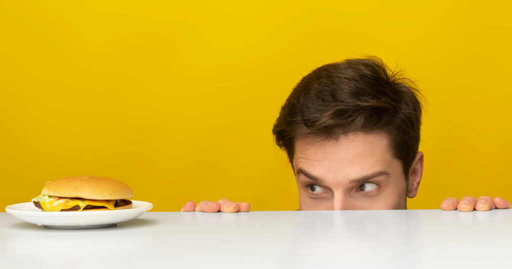 a man hiding while eating