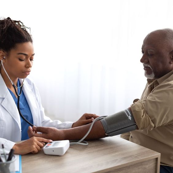 a doctor checking a patient's blood pressure