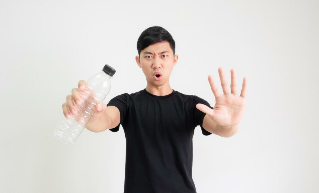 A man holding an empty water bottle