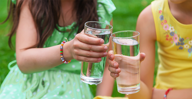 two women holding cups of water