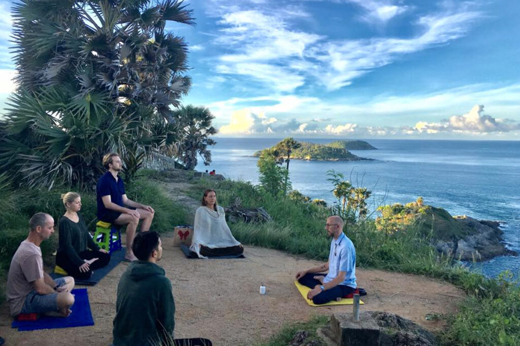 a man teaching others yoga