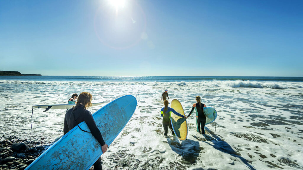 five people skating in the sea