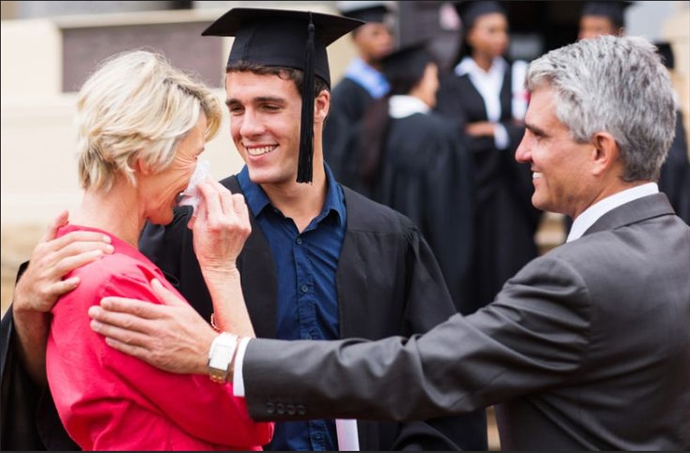 a graduating boy and his crying mother