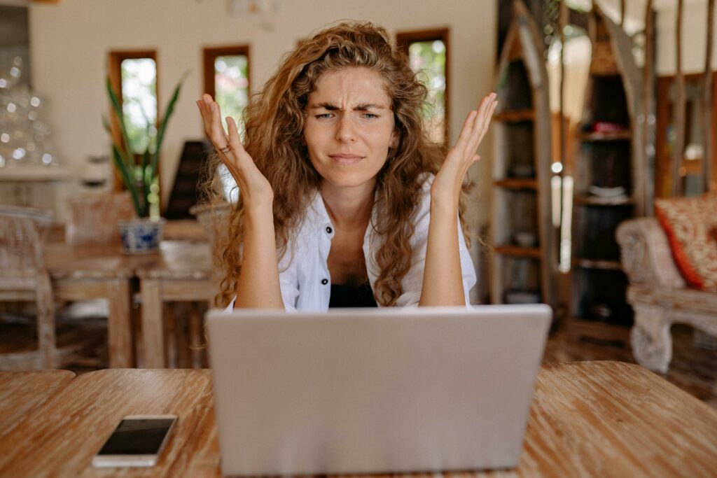 a woman who looked confused while looking at her laptop