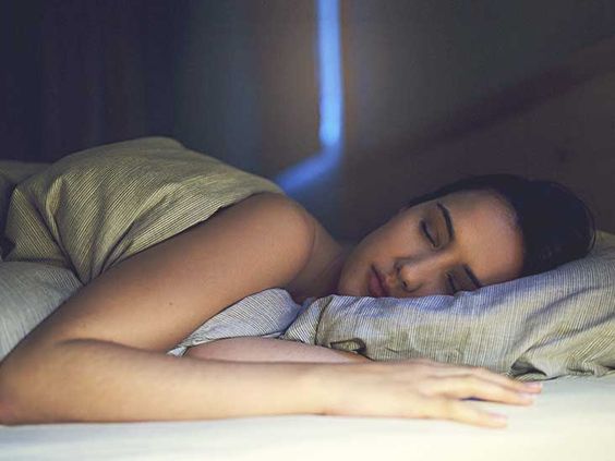 a lady sleeping on the bed