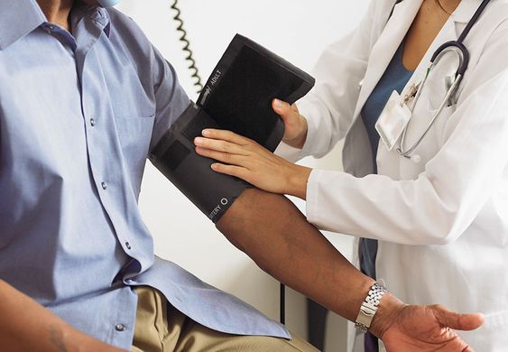 a doctor checking blood temperature of his patient