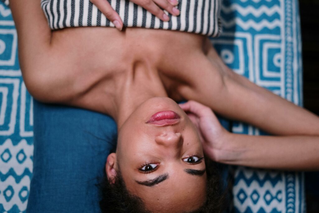 a woman Lying on Blue Textile