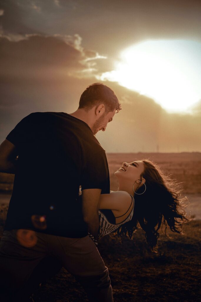 Positive couple dancing in nature