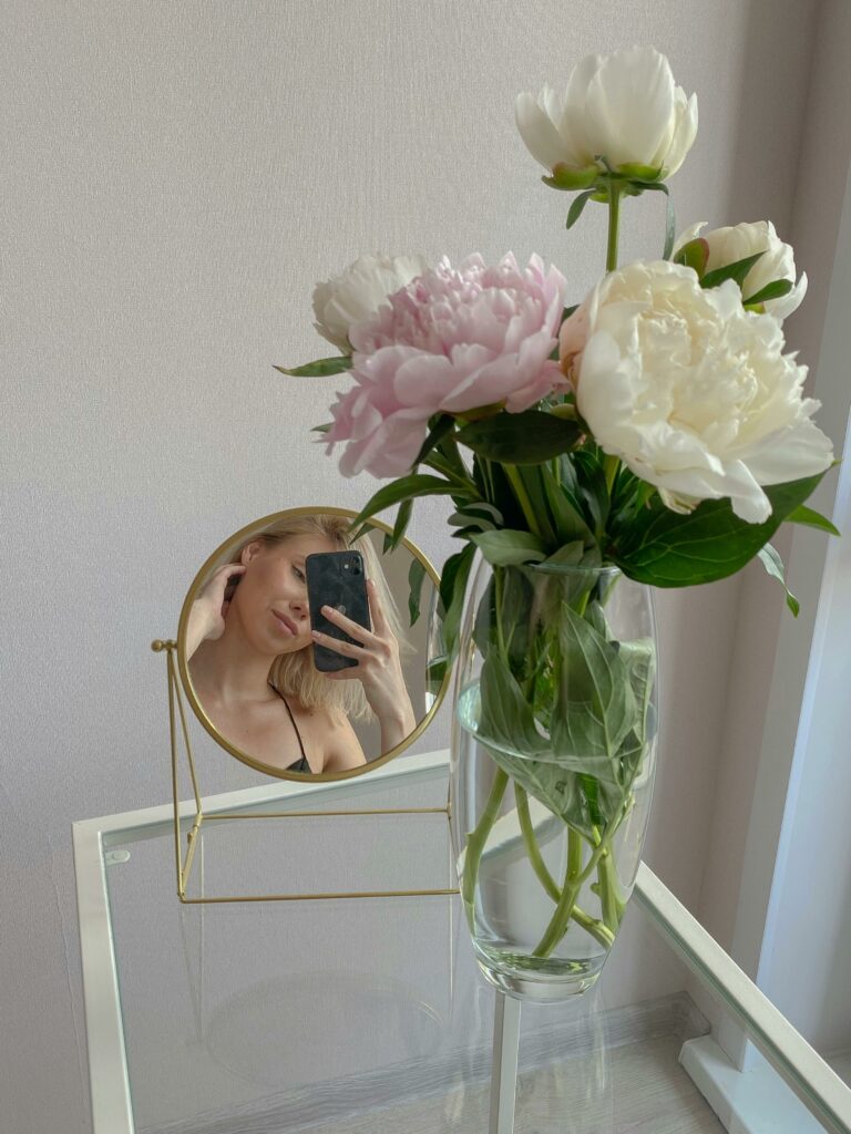 Woman Taking Photo in Front of a Round Mirror