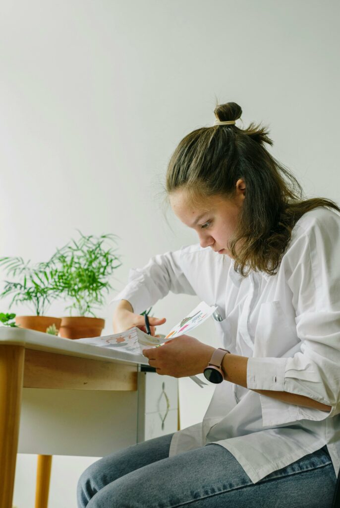 Woman in White Dress Shirt Holding a Paper