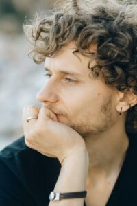 A Close-Up Shot of a Curly-Haired Man