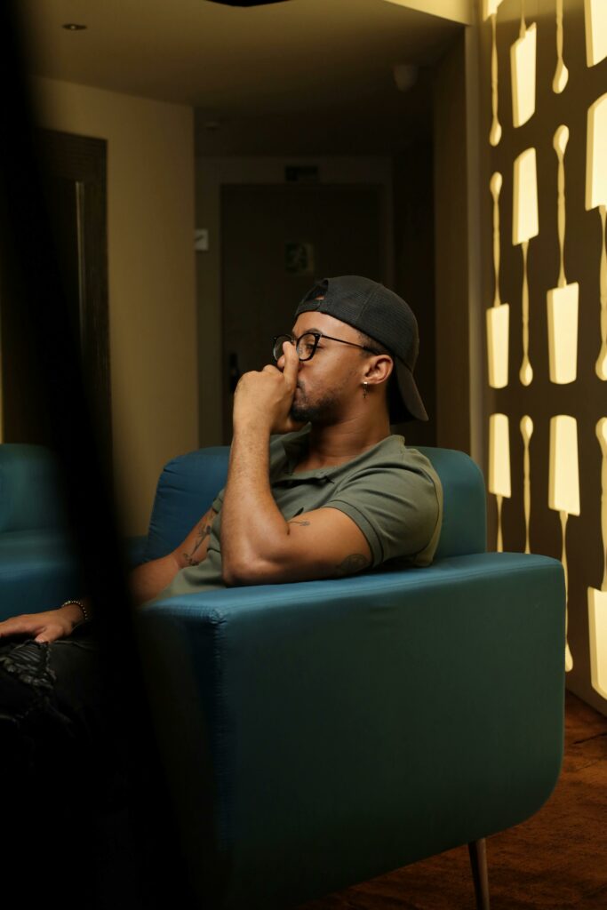 Pensive Man sitting on a Blue Chair