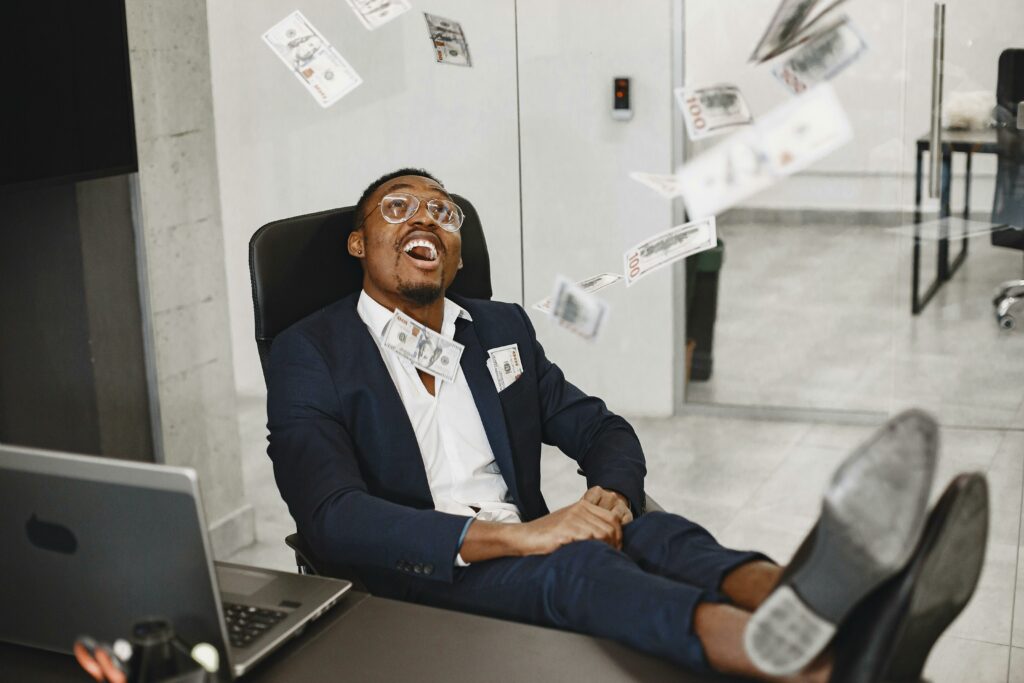 a man sitting in his office with lot of money