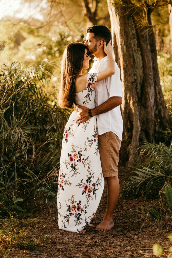 Romantic couple hugging in lush forest