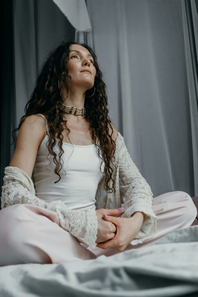 Woman in White Outfit Sitting while Looking Afar