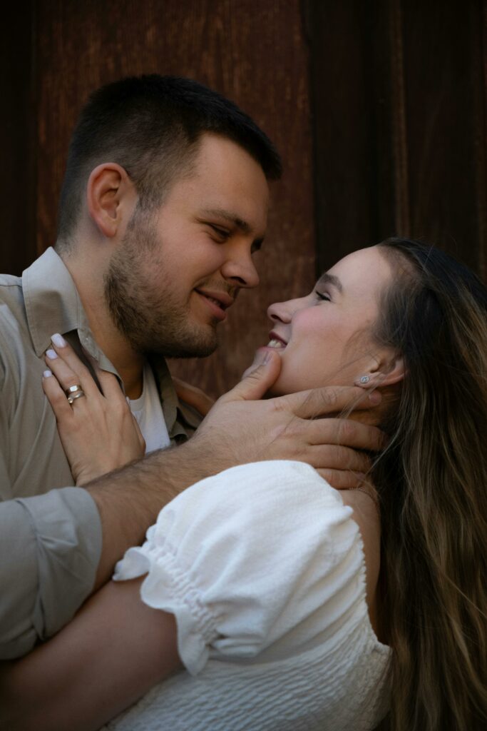 Man Holding Smiling Woman by Neck